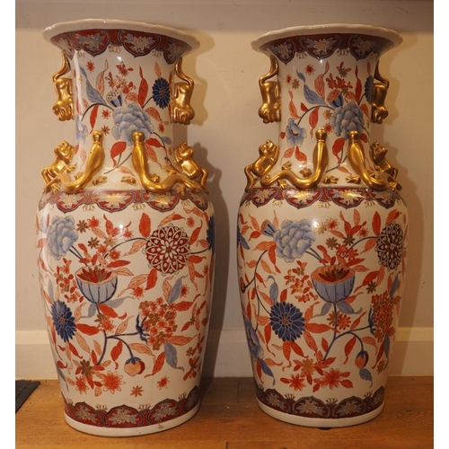 92 - A pair of Chinese Imari palette baluster vases with flower and leaf decoration and applied mythical ... 