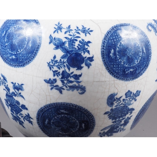 95 - A Chinese blue and white bulbous vase, decorated circular panels, flowers and fruit, 10 1/4