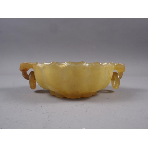 99 - A Chinese jade lotus dish with ring handles, 5 3/4