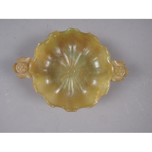 99 - A Chinese jade lotus dish with ring handles, 5 3/4