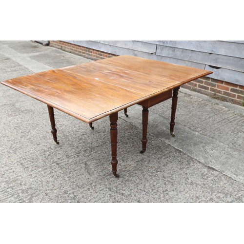 403 - A 19th century mahogany dropleaf dining table on turned and castored supports, 48