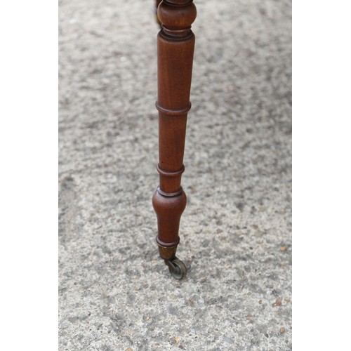 403 - A 19th century mahogany dropleaf dining table on turned and castored supports, 48