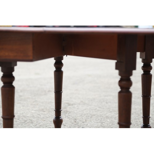 403 - A 19th century mahogany dropleaf dining table on turned and castored supports, 48