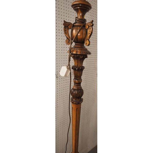 216 - A polished as walnut and carved standard lamp, on circular base