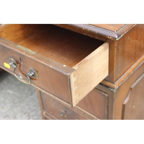 470 - A mahogany double pedestal desk, inset red leather top over nine drawers, 53” wide x 26” deep x 30” ... 