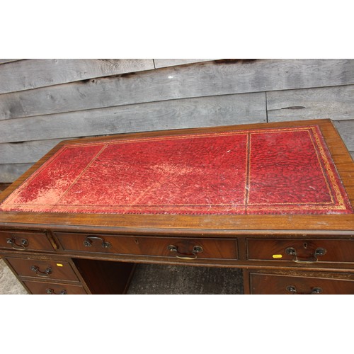 470 - A mahogany double pedestal desk, inset red leather top over nine drawers, 53” wide x 26” deep x 30” ... 