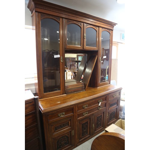 485 - An Edwardian carved walnut sideboard/dresser, the upper section fitted four glazed doors and central... 