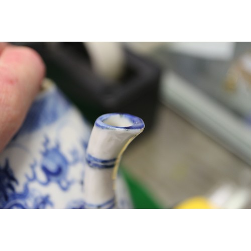 83 - A Chinese blue and white ovoid teapot with associated lid, dragon and cloud decoration, four-charact... 