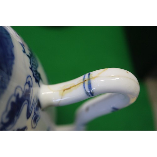 83 - A Chinese blue and white ovoid teapot with associated lid, dragon and cloud decoration, four-charact... 