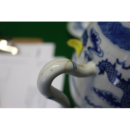 83 - A Chinese blue and white ovoid teapot with associated lid, dragon and cloud decoration, four-charact... 