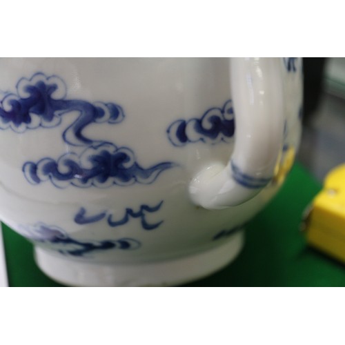 83 - A Chinese blue and white ovoid teapot with associated lid, dragon and cloud decoration, four-charact... 