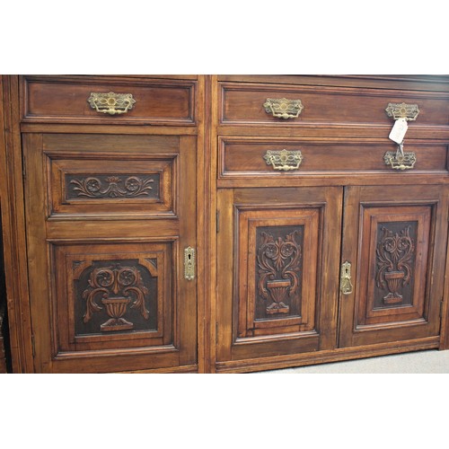 485 - An Edwardian carved walnut sideboard/dresser, the upper section fitted four glazed doors and central... 