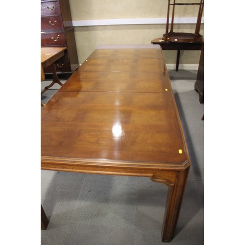 483 - An American figured walnut and banded extending dining table with two extra leaves, on square suppor... 