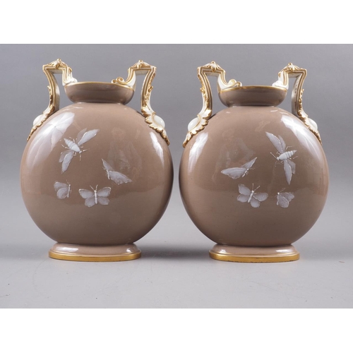 18 - A pair of mid 19th century porcelain pate-sur-pate two-handle moon flasks with fern and insect decor... 