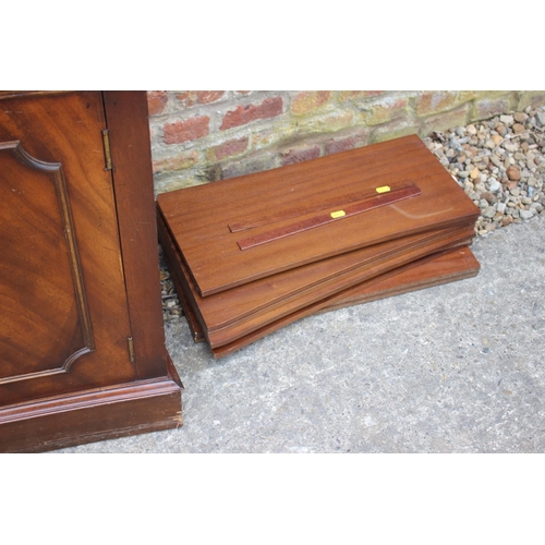 426 - A figured mahogany concave bookcase of Georgian design enclosed three Gothic glazed panel doors over... 