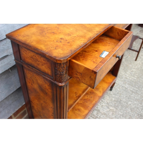 427 - A Theodore Alexander burr walnut bookcase of Louis XVI design, fitted two drawers over open shelves,... 