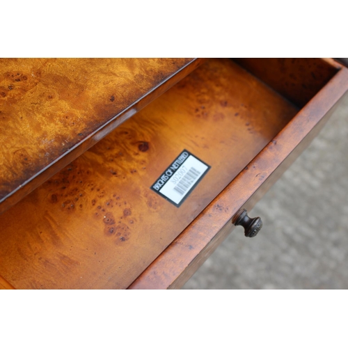 427 - A Theodore Alexander burr walnut bookcase of Louis XVI design, fitted two drawers over open shelves,... 