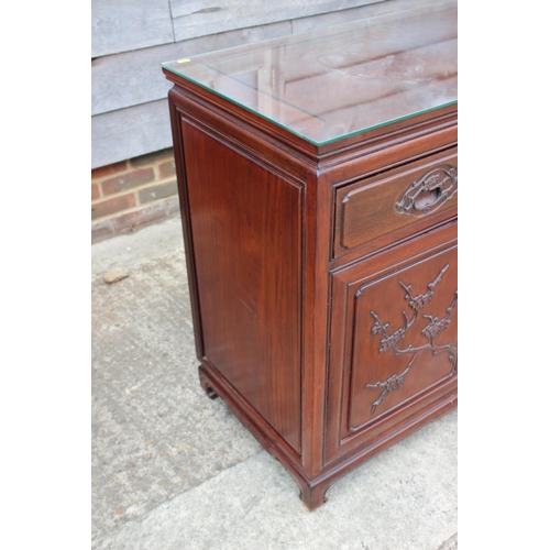 430 - A Chinese hardwood sideboard, fitted four drawers over two pairs of cupboard doors with applied bamb... 