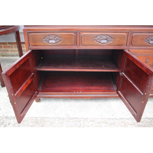 430 - A Chinese hardwood sideboard, fitted four drawers over two pairs of cupboard doors with applied bamb... 