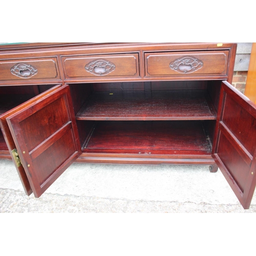 430 - A Chinese hardwood sideboard, fitted four drawers over two pairs of cupboard doors with applied bamb... 