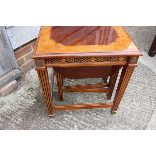 434 - A mahogany and ash banded nest of three occasional table, on reeded supports and brass feet, 20