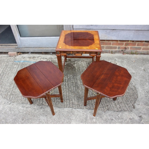 434 - A mahogany and ash banded nest of three occasional table, on reeded supports and brass feet, 20