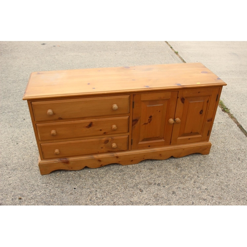 446 - A pine side cupboard, fitted three drawers and enclosed two doors, 52