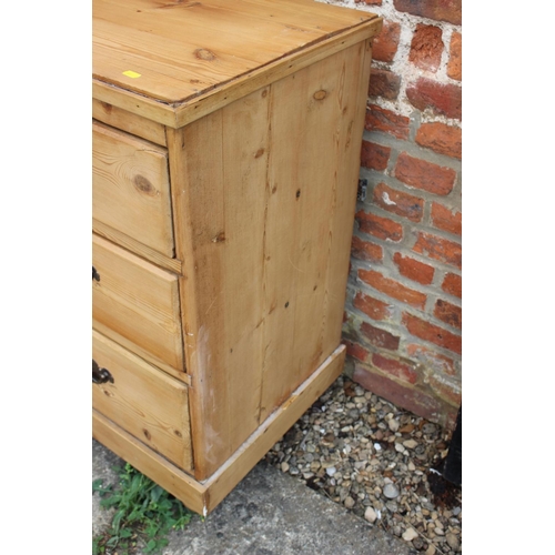 450 - A waxed pine chest of two short and two long drawers with brass handles, on turned supports, 36