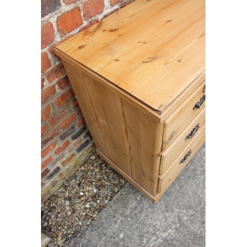 450 - A waxed pine chest of two short and two long drawers with brass handles, on turned supports, 36