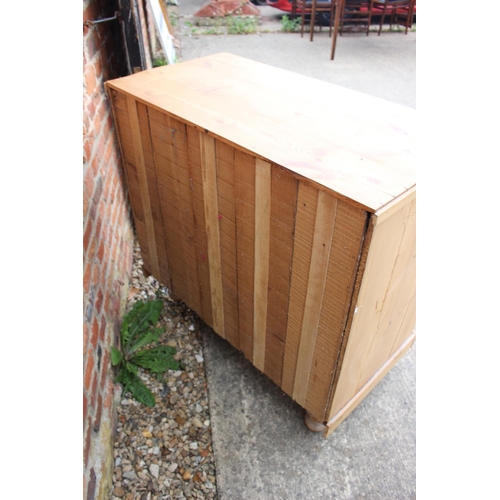 450 - A waxed pine chest of two short and two long drawers with brass handles, on turned supports, 36