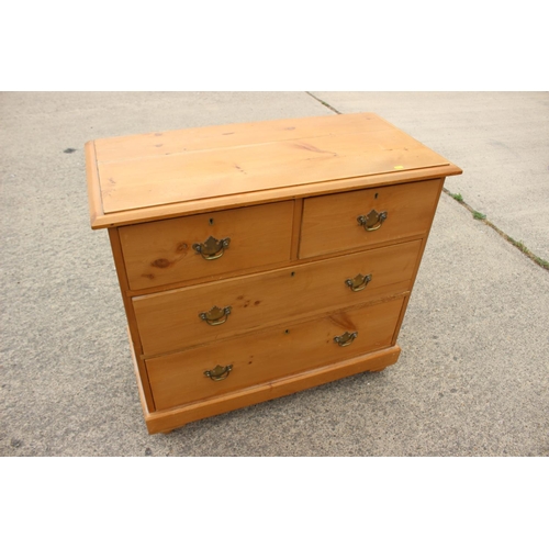 451 - A waxed pine chest of two short and two long drawers with brass handle plates, 34