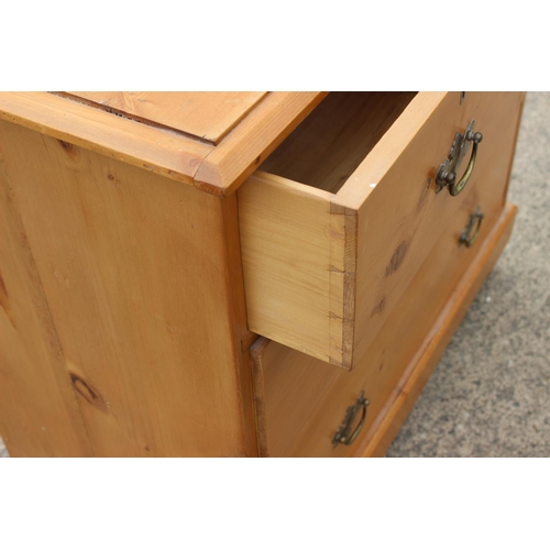 451 - A waxed pine chest of two short and two long drawers with brass handle plates, 34