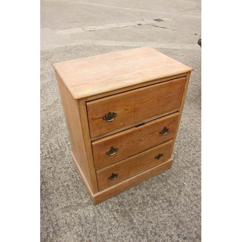 454 - A stripped pine chest of three drawers, on block base, 27