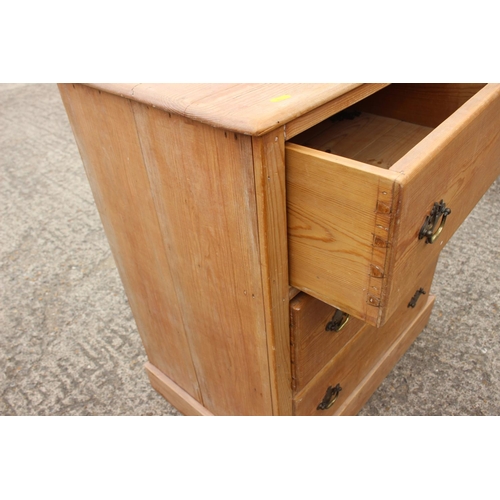 454 - A stripped pine chest of three drawers, on block base, 27