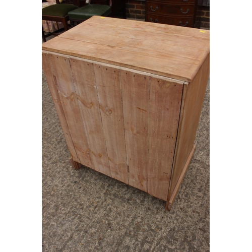 454 - A stripped pine chest of three drawers, on block base, 27