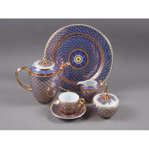 70 - A Thai porcelain coffee set, decorated in a yellow, crimson and gilt floral pattern on a blue ground... 