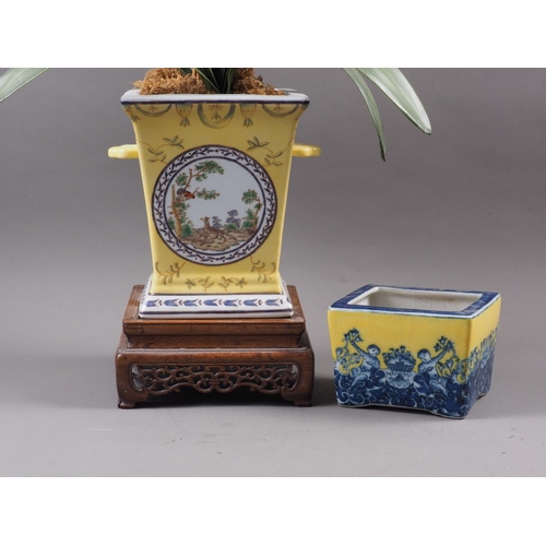 78 - A porcelain yellow ground blue and white decorated two-handled jardiniere, on carved hardwood stand,... 