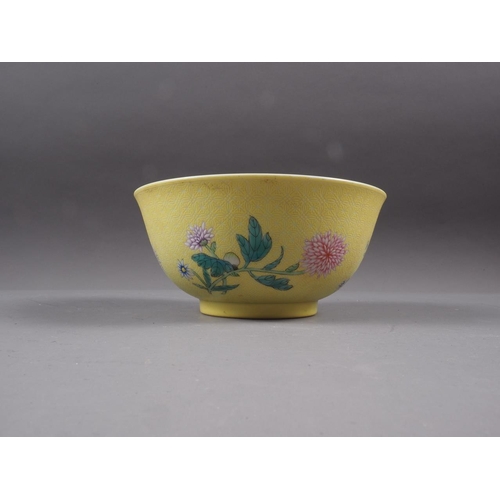 86 - A Chinese yellow glazed bowl with interior bat decoration and exterior chrysanthemum decoration, sea... 