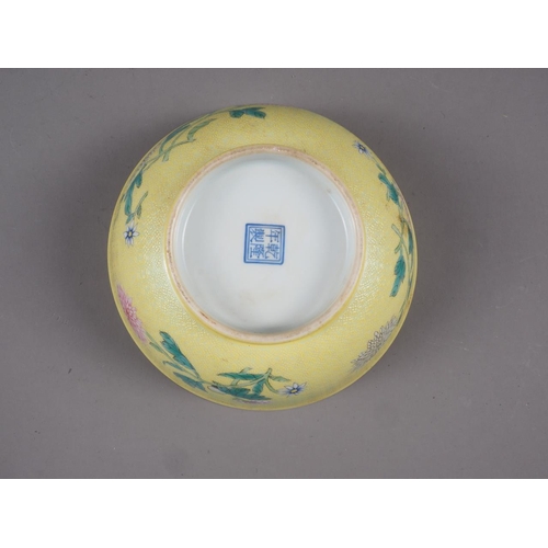 86 - A Chinese yellow glazed bowl with interior bat decoration and exterior chrysanthemum decoration, sea... 