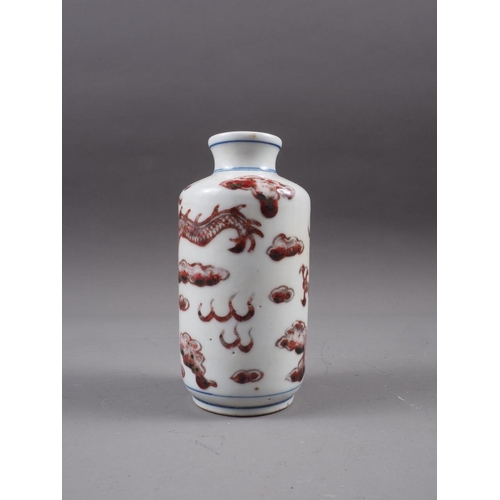 87 - A Chinese baluster vase with iron oxide glaze and dragon and cloud decoration, six-character mark to... 