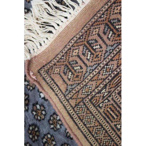 455 - A Middle Eastern rug with central medallion and multi-borders in shades of natural and grey, 48