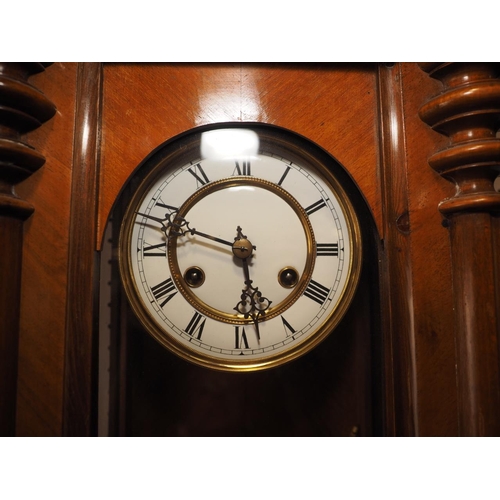 102 - A late 19th century walnut cased Vienna type wall clock with white enamel dial and eight-day strikin... 