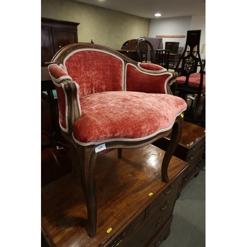 429 - A carved mahogany showframe dressing chair of Louis XVI design, upholstered in a salmon velour, on c... 