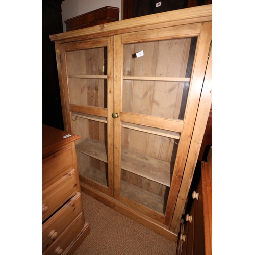 439 - A 19th century waxed pine side cabinet enclosed two glazed doors, 41 1/2