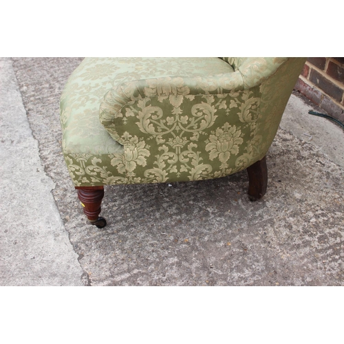 413 - A 19th century tub-shape armchair, button upholstered in a green floral brocade, on turned and casto... 