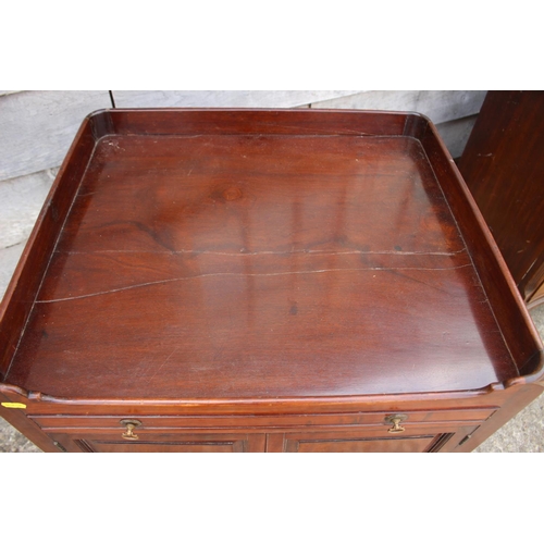 414 - A Georgian mahogany tray top bedside stand, fitted drawer over cupboards and deep drawer, on moulded... 