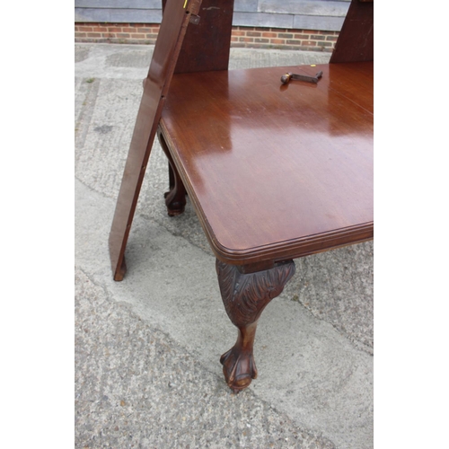 443 - A late 19th century mahogany extending dining table with three extra leaves and winder, on cabriole ... 