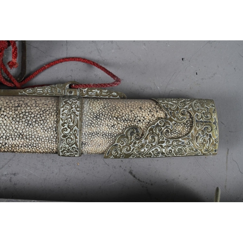 156 - A Oriental sword with shagreen sheath and brass mounts, 18 1/2