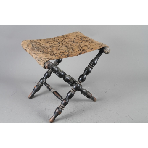 176 - A stonemason's mallet, a Victorian ebonised bobbin turned footstool and a wooden model of a 16th cen... 