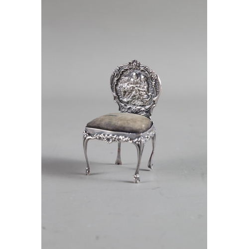 229 - A William Comyns silver miniature chair pin cushion, and a silver mounted scent bottle (no stopper)